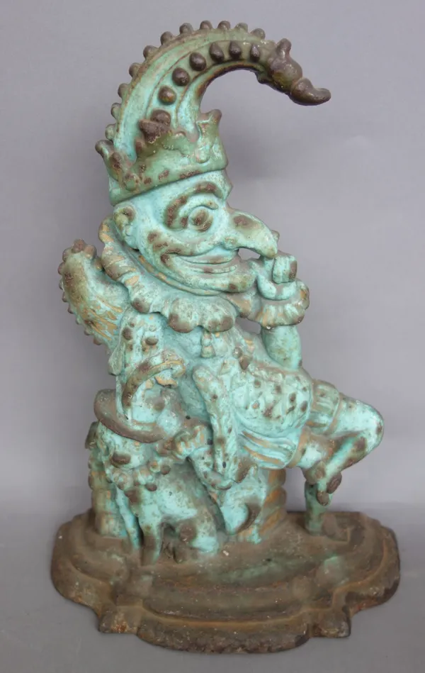A 19th century patinated cast iron Mr Punch half block doorstop (31cm high), a Victorian cast iron dragon door stop and another modelled as a basket o