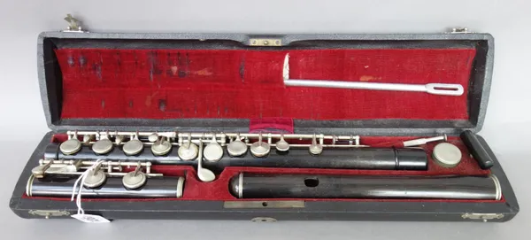 A rosewood and white metal mounted flute by Conrad Mollenhauer, Fulda, early 20th century, no.321, in original fitted case, the flute 68cm long.