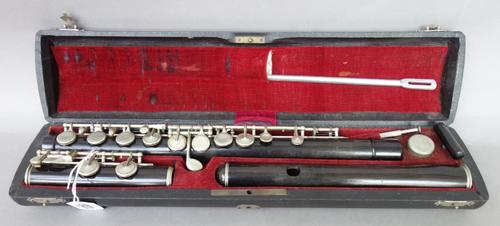 A rosewood and white metal mounted flute by Conrad Mollenhauer, Fulda, early 20th century, no.321, in original fitted case, the flute 68cm long.