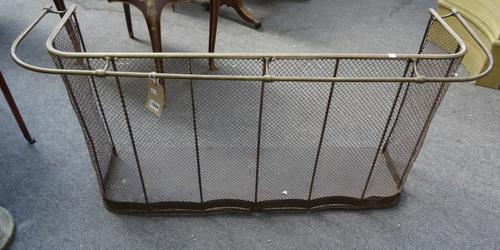 A Victorian brass and wire mesh fire fender with hanging rail (134cm wide) and one other Victorian brass and wire mesh fender (110cm wide) (2).