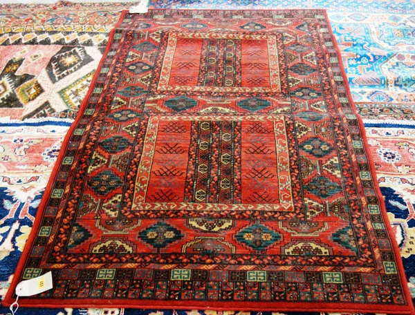 A machine made Turkman Ensi rug with red ground, 180cm x 122cm.  M2