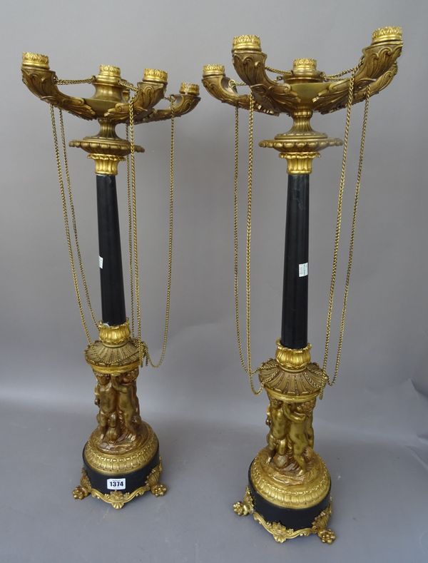 A pair of Empire style gilt metal five branch candelabra, 20th century, the moulded sconces of oil lamp form, united by chains, over a faux marble col
