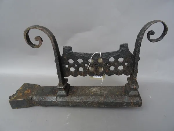 A pair of early Victorian cast iron boot scrapers, each with pierced footplate, flanked by scroll support on a chamfered base, 46cm wide, (2).
