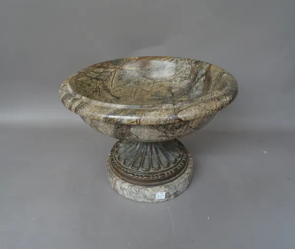 A near pair of serpentine marble footed urns, 20th century, of turned circular form, with fluted metal socle, 35cm diameter, and one smaller matching