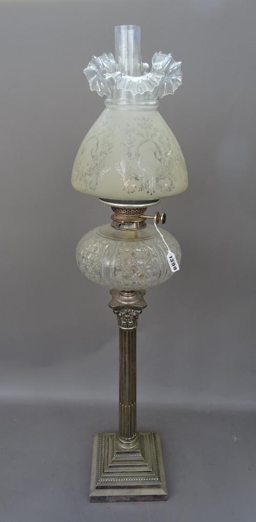 A Victorian and later, silver plated and glass oil lamp, the base of Corinthian column form, with a cut glass reservoir, Duplex burner and a later etc