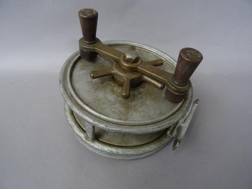 A Hardy 'Fotuna' 7 inch sea fishing reel, twin reverse taper handles on a brass bar, star drag and six screw brass foot, indistinct stamped marks, (a.