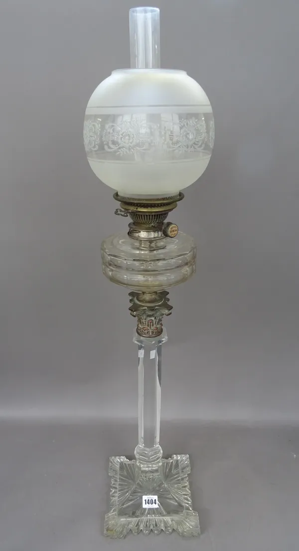 A Victorian cut glass oil lamp, on a heavy square shaped foot with hexagonal column, Corinthian metal capital, faceted circular reservoir, Hinks/Messe