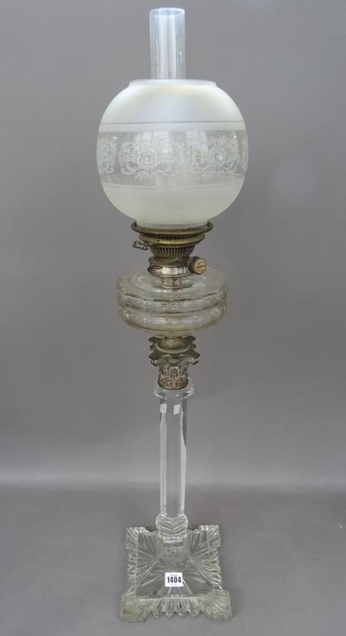 A Victorian cut glass oil lamp, on a heavy square shaped foot with hexagonal column, Corinthian metal capital, faceted circular reservoir, Hinks/Messe