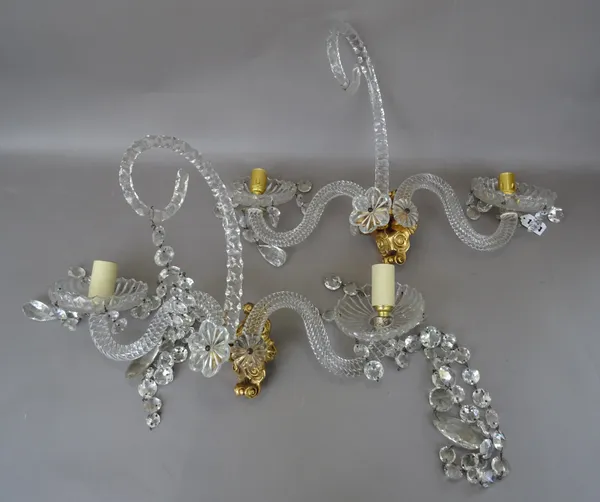 A pair of Georgian style twin branch cut glass wall appliques, each gilt bronze back plate issuing two swan neck spiral twist branches and a central g