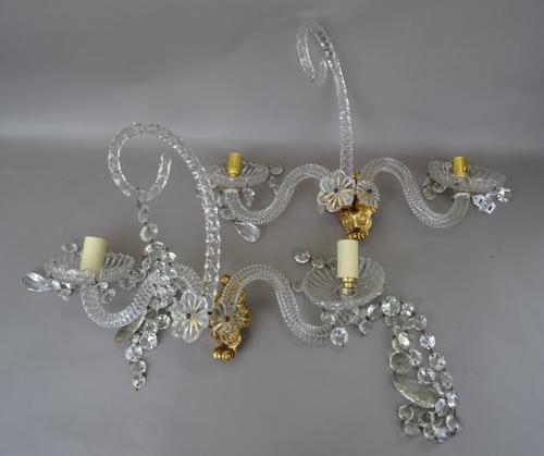 A pair of Georgian style twin branch cut glass wall appliques, each gilt bronze back plate issuing two swan neck spiral twist branches and a central g