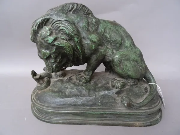 After Barye, a French bronze animalier figure of 'Lion and Serpent', raised on a naturalistic shaped base, 35cm wide.