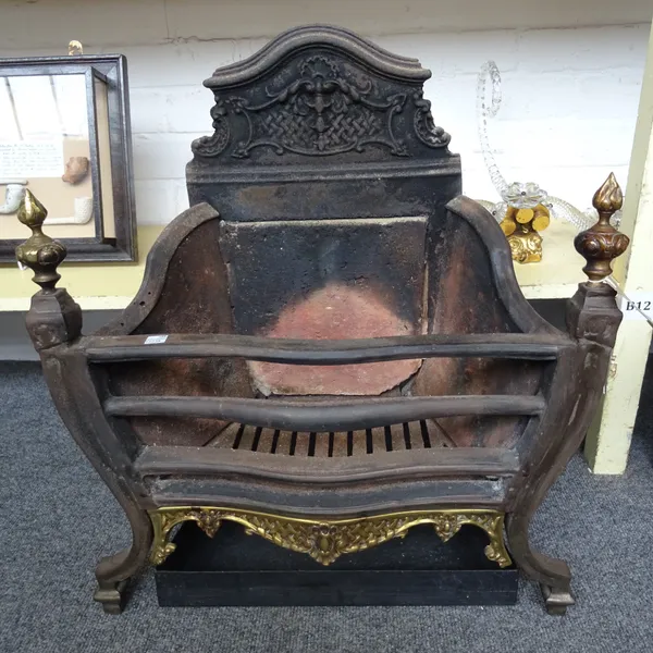 A Georgian style steel, brass and cast iron three bar fire grate, of serpentine form, with s foliate cast shaped backplate and flaming urn finials, 58