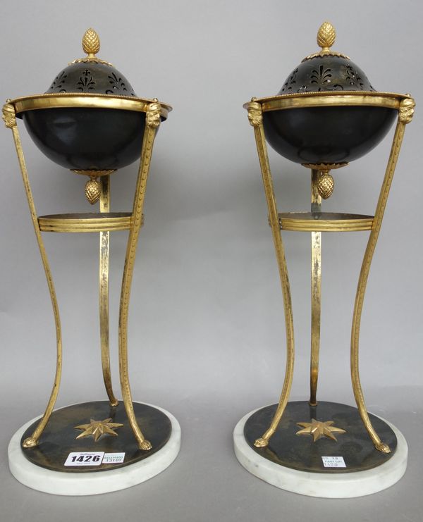 A pair of Louis XVI style bronze and ormolu pastille burners, each of circular form over a triform hoofed body and circular marble plinth, 41cm high,