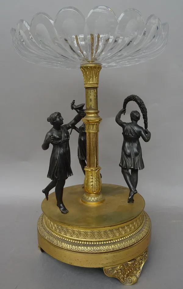 A French Empire gilt metal, glass and bronze centrepiece tazza in the manner of Thomire, the glass dished top over a circular gilt metal body set with