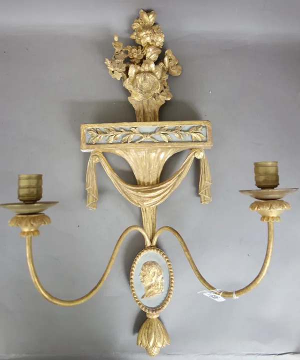 A pair of Georgian giltwood two branch wall appliques, early 19th century, each with foliate carved surmount over a 'swag' form back plate terminating