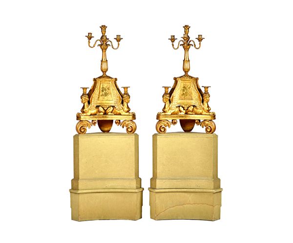 A pair of Italian Neo-Classical giltwood corner candelabra, circa 1820, each with four branch surmount over a foliate carved column with two anthropom