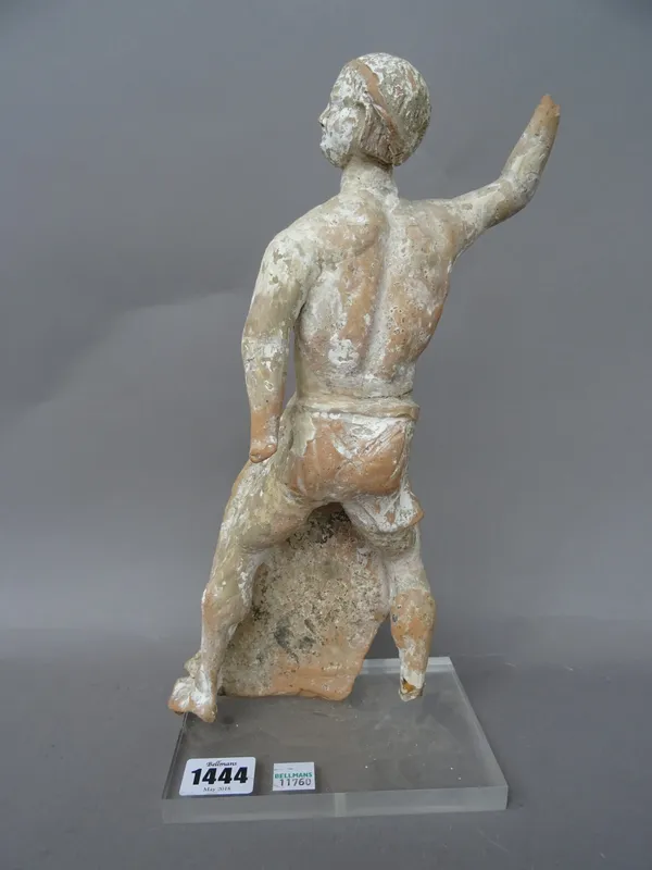 A Canosan type terracotta figure of a gladiator (30cm high) on a clear Perspex stand.