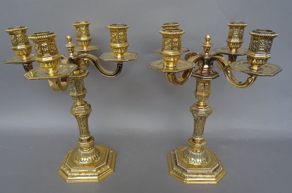 Christofle Paris, a pair of Louis XIV style gilt and silvered four light candelabra of canted square form, marked to underside, 29cm high, (2).  Illus
