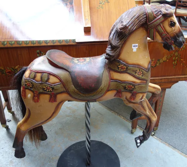 A European polychrome painted carved wooden carousel horse, mounted on a metal stand, (a.f), the horse 93cm high.