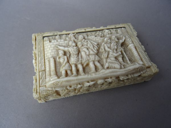A Continental carved ivory snuff box, 19th century, each panel independently carved with a mythological scene, interior provenance label detailed "lef