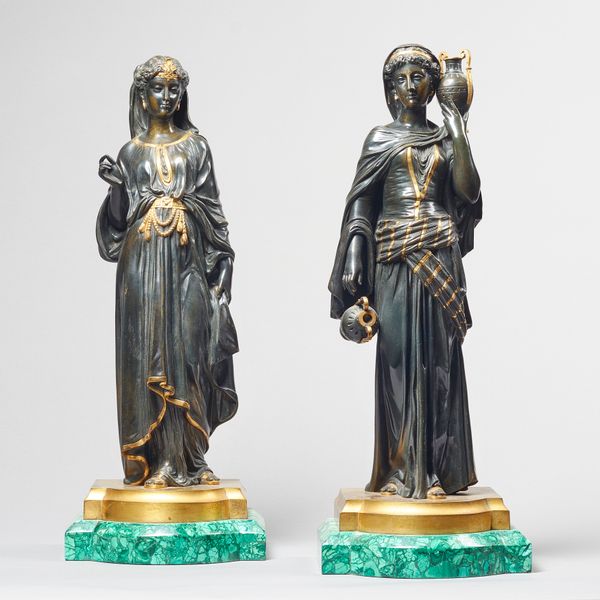 A pair of French bronze and gilt decorated figures of Egyptian maidens, late 19th century, each raised on a bow front malachite plinth, 42cm high over