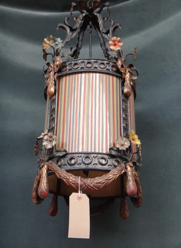 A tôle peinte hall lantern, circa 1900, possibly German, the circular body embellished with painted flowers and swags enclosing striped glass shades,