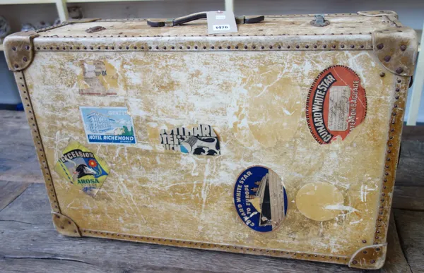 A faux leather travel trunk circa 1930, monogrammed C.E.S. with Cunard white star travel labels (76cm wide) and another similar dark blue suitcase, (2