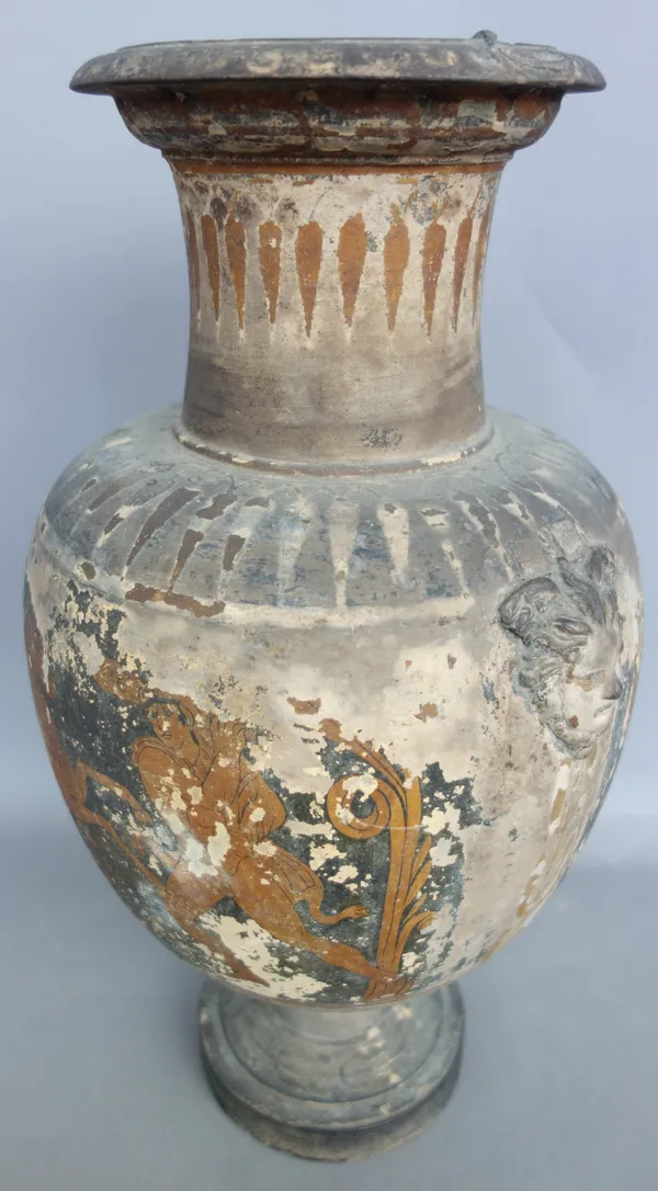 A Roman style terracotta baluster vase with twin moulded mask handles, indistinctly decorated with a band of mythological figures over a circular foot