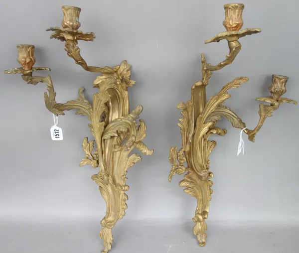 A pair of Louis XV style gilt metal two branch wall appliques, late 19th century, of scroll foliate form, 55cm high, (2).