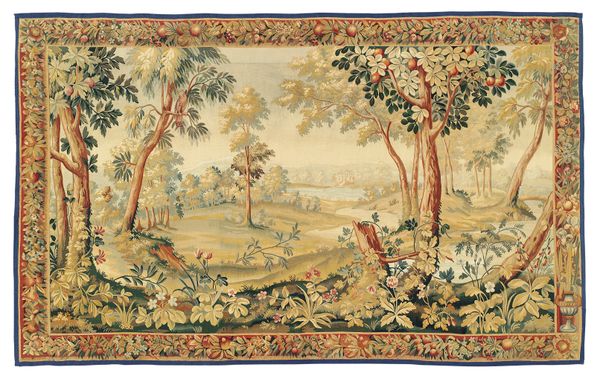 A North European pastoral tapestry, 20th century, woven in coloured wools depicting a forest clearing with a waterscape, within a foliate and fruit fi