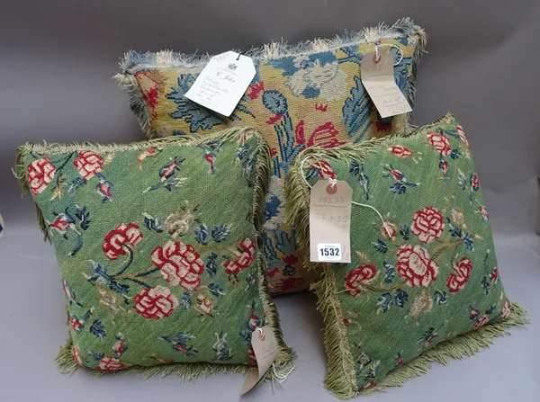 A pair of French needlework cushions, each woven with flowers on a green ground and another larger woven in blue, cream, mustard and red, the pair 32c