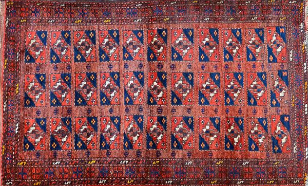 An Afghan Esari rug, the field with three columns of eleven compartments each with a gul motif, a flowerhead border, 162cm x 102cm.  Illustrated