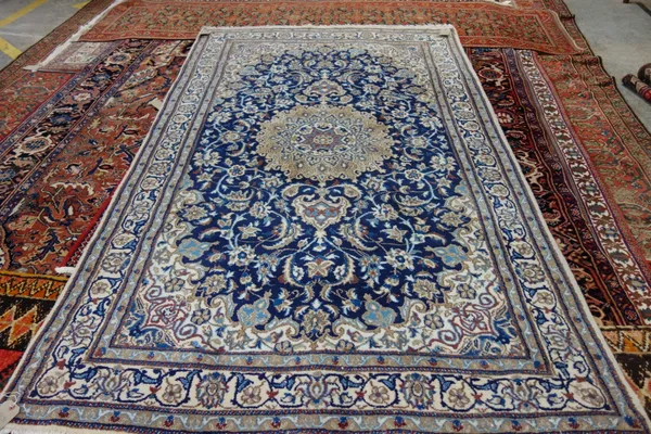 A part silk Nain rug, Persian, indigo field with central roundel, 258cm x 155cm.  M7