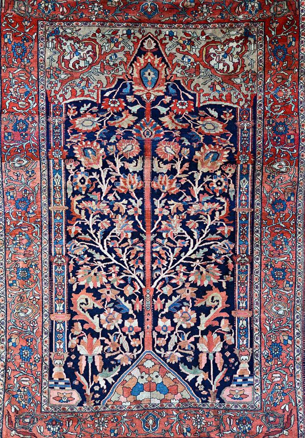 A Mahal Tree of Life prayer rug, Persian, the dark indigo mihrab filled with a floral tree, bold palmette at top, two bold palmettes in arch, columns