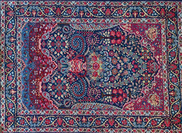 A pair of Tabriz prayer rugs, Persian, the dark indigo floral mihrab with a large vase, supported by Cypress trees, a madder arch, an indigo leaf bord