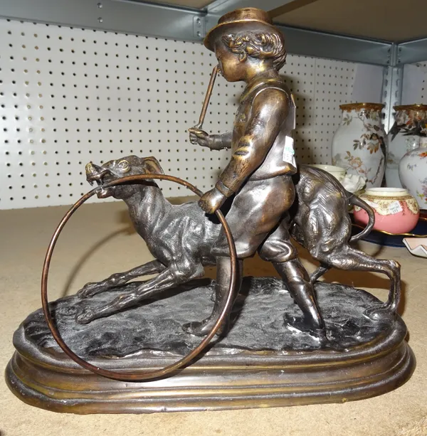 A 20th century bronze model of a boy and dog, after J Moigniez, 28cm wide x 26cm high.  C9