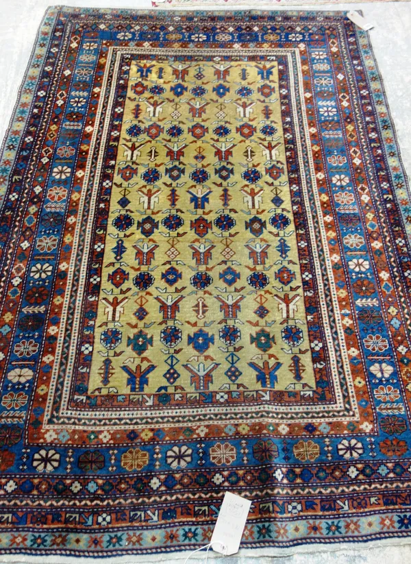 An Erivan rug, Caucasian, the saffron field with an allover stylised flower motif, an indigo flowerhead and leaf border, 183cm x 123cm.
