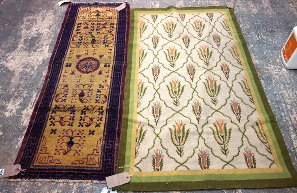 A Samarkand runner, the saffron field with a central aubergine roundel, floral sprays and a vase of sprays to each end, an aubergine waved vine border