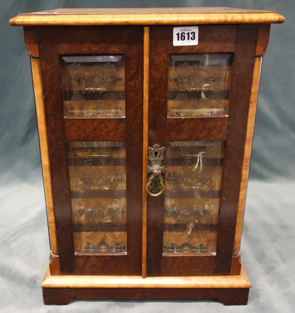 A Victorian bird's eye maple table top collector's cabinet, the pair of double panel bevelled glazed doors enclosing seven graduated drawers, on brack