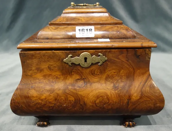 A 19th century and later figured walnut square tea caddy, of bloated bombé form, the lift top enclosing four lidded canisters, on paw feet, 25.5cm wid