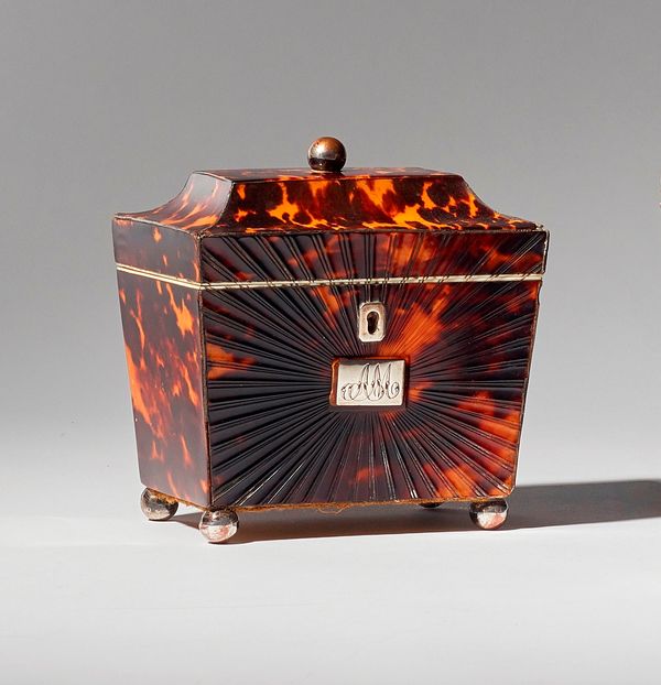 A Regency tortoiseshell and ivory tea caddy of sarcophagus form, with single lidded interior, 11.5cm wide x 12cm high x 8cm deep.  Illustrated