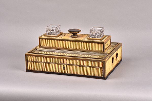 A 19th century Anglo-Indian porcupine quill and horn desk stand, with pair of inkwell recesses and concave pen trays, above a single drawer base, 33cm
