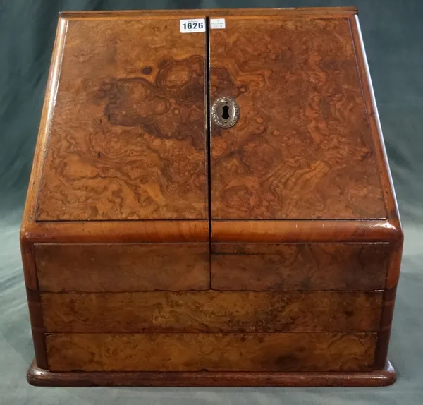 A Victorian figured walnut slope front stationary box, with fitted interior and sprung single drawer base, 42cm wide x 39.5cm high x 30cm deep.