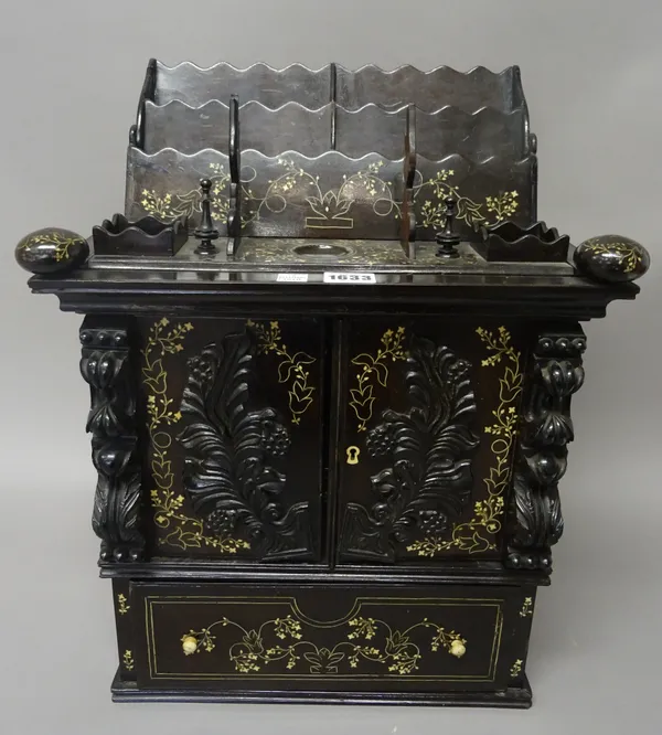 A 19th century Anglo-Indian bone inlaid coromandel table top writing cabinet, with pair of carved doors, revealing a fall-down writing surface, over s
