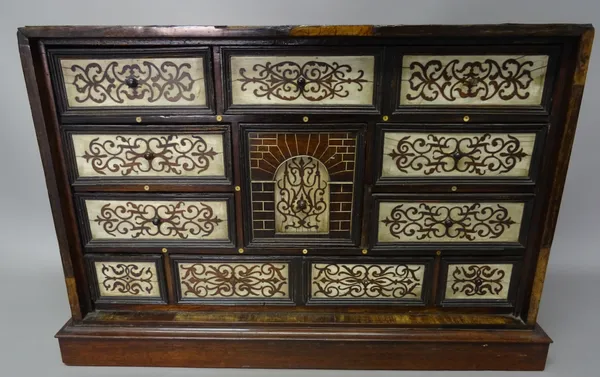 A late 17th century/early 18th century Portuguese bone inlaid rosewood table cabinet, the central drawer with deceptive cube inlaid decoration surroun