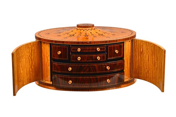 Max Cooper; an oval table top collector's box, the specimen wood marquetry inlaid rosewood banded satinwood two door case, revealing a fitted cedar wo