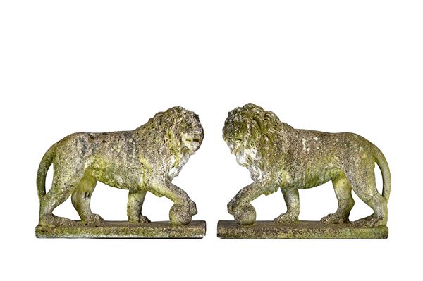 A pair of reconstituted stone figures of Medici lions, each with one paw raised on a sphere, on rectangular bases, 73cm wide x 55cm high, (2).  Illust