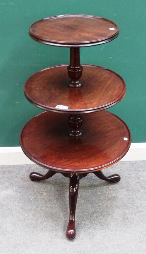 A George III graduated mahogany circular three tier dumb waiter, on tripod base, 58cm wide x 105cm high.