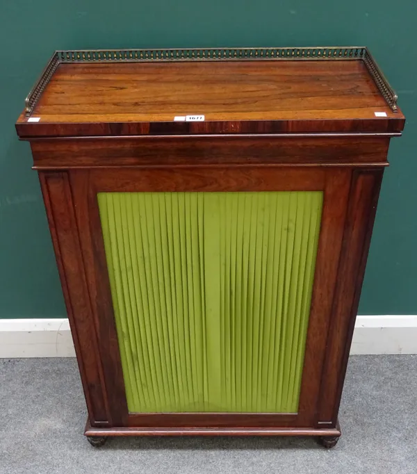 A Regency rosewood side cabinet, the brass galleried top over single pleated silk door, on melon carved feet, 67cm wide x 92cm high x 32cm deep.