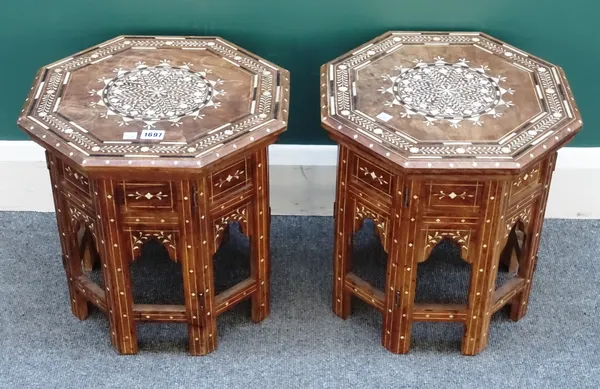 A pair of 20th century Moorish bone inlaid octagonal tables, on folding stands with Islamic arch decoration, 37cm wide x 39cm high, (2).